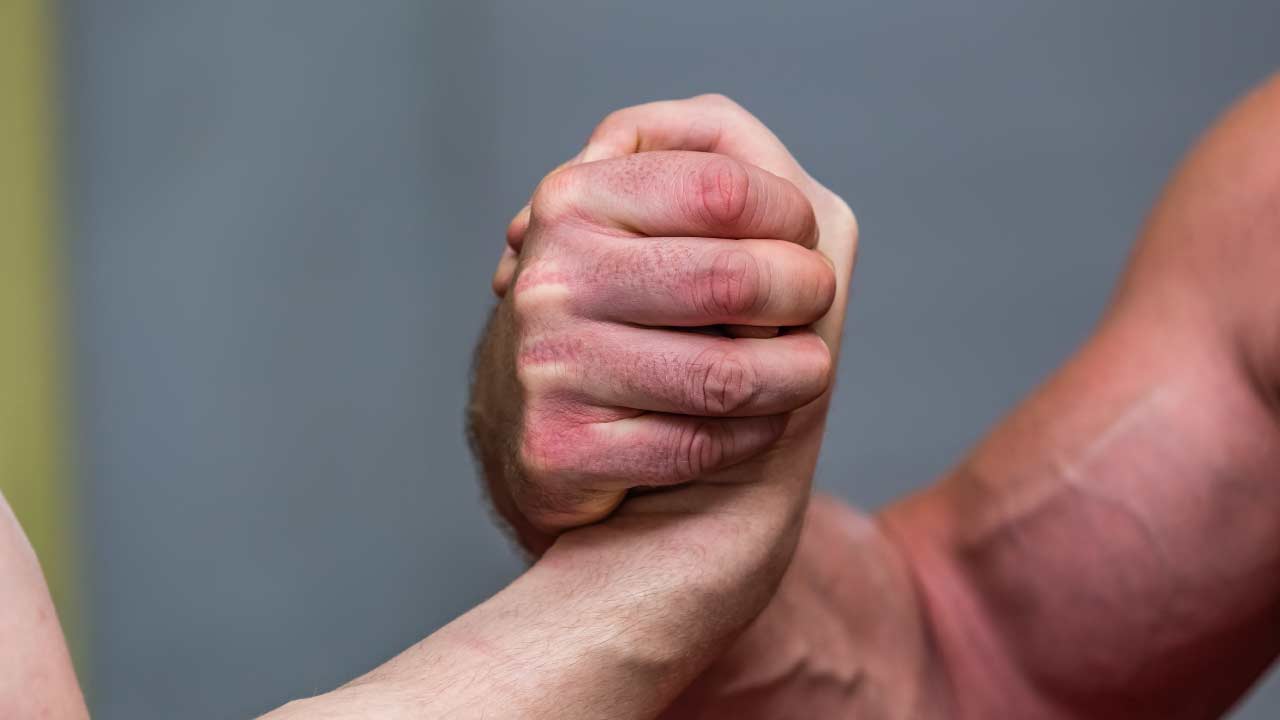 close-up of two guys arm wrestling