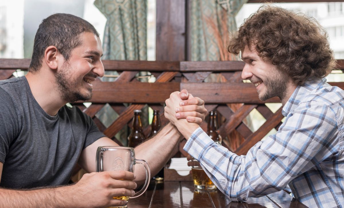 Two guys arm wrestling spontaneously in a pub